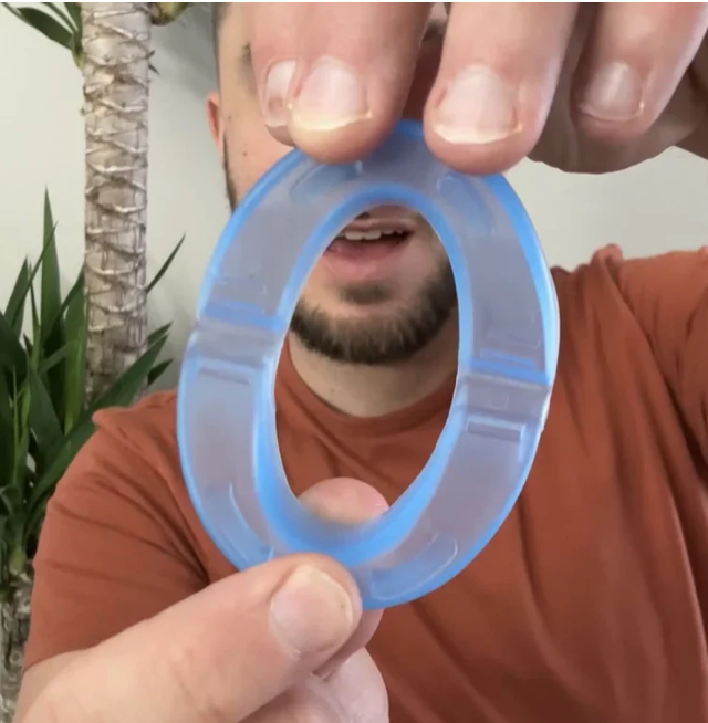 Hands holding the clear mouthpiece